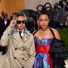 Japanese tennis player Naomi Osaka (R) and US singer Cordae arrive for the 2021 Met Gala at the Metropolitan Museum of Art on September 13, 2021 in New York. - This year's Met Gala has a distinctively youthful imprint, hosted by singer Billie Eilish, actor Timothee Chalamet, poet Amanda Gorman and tennis star Naomi Osaka, none of them older than 25. The 2021 theme is "In America: A Lexicon of Fashion." 
