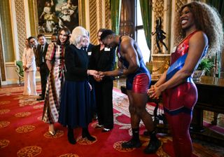 Gladiator Nitro, also known as Harry Aikines-Aryeetey speaks with British actors Matt Lucas and Rob Brydon during a reception hosted by Britain's Queen Camilla for finalists, judges and celebrity readers, to celebrate the final of the BBC's creative writing competition at Buckingham Palace in central London on February 26, 2025