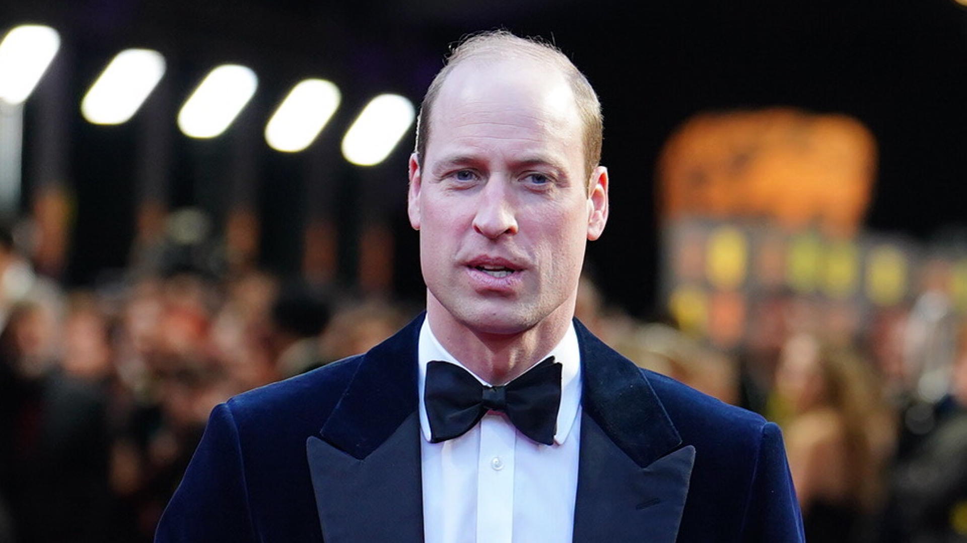 Prince William wears a tuxedo and bow tie on the red carpet