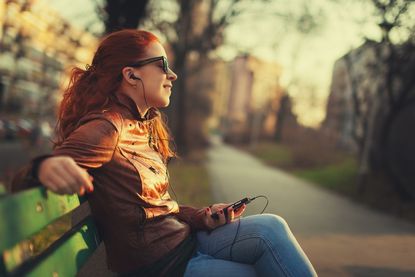 a woman listening to music through headphones.