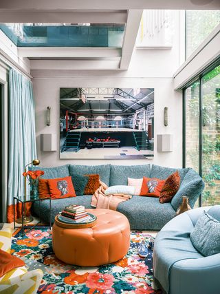 blue sofa with red cushions in a small living room