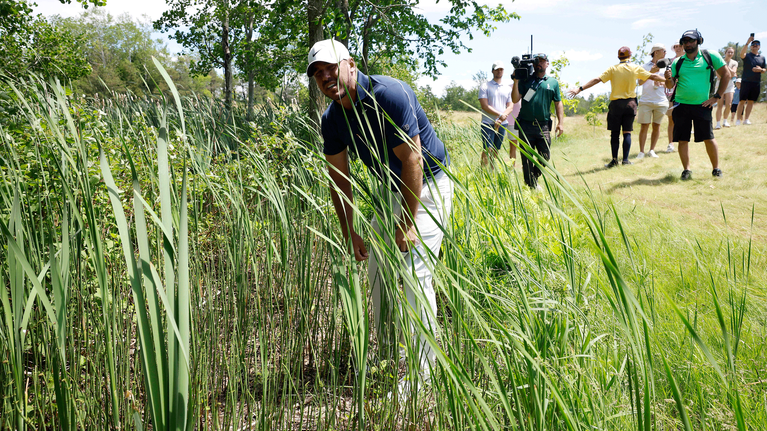 Brooks Koepka hunts for a lost ball during round three of the 2026 RBC Canadian Open