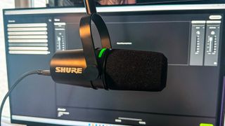 Shure MV7+ in front of a gaming monitor