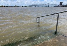 The Mississippi River laps at the stairs on a protective levee in New Orleans as Tropical Storm Barry approaches on July 11, 2019.