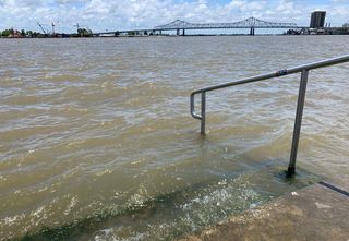 The Mississippi River laps at the stairs on a protective levee in New Orleans as Tropical Storm Barry approaches on July 11, 2019.