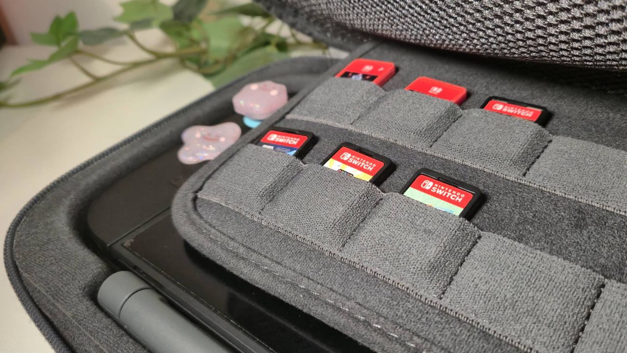 Photo of some Switch and Switch 2 games sitting inside the Belkin Charging Case Pro.