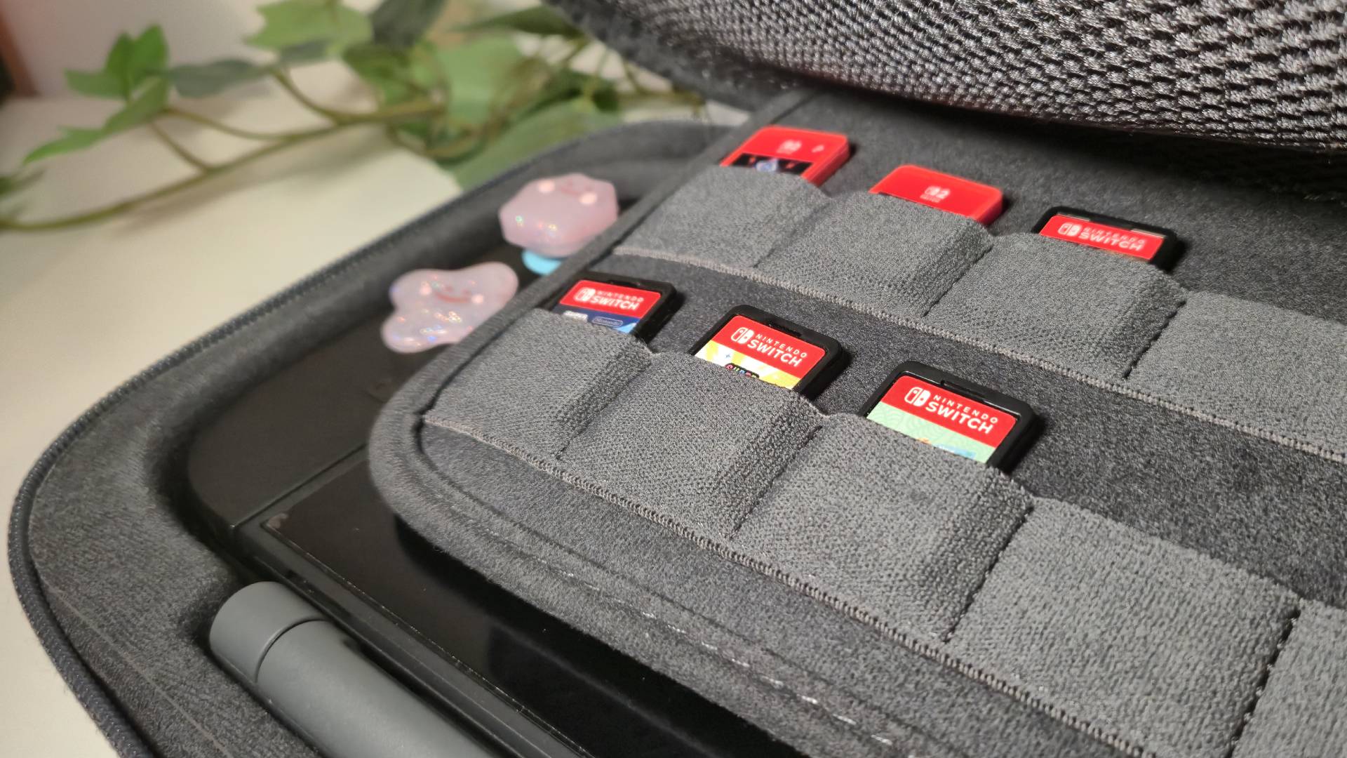 Photo of some Switch and Switch 2 games sitting inside the Belkin Charging Case Pro.