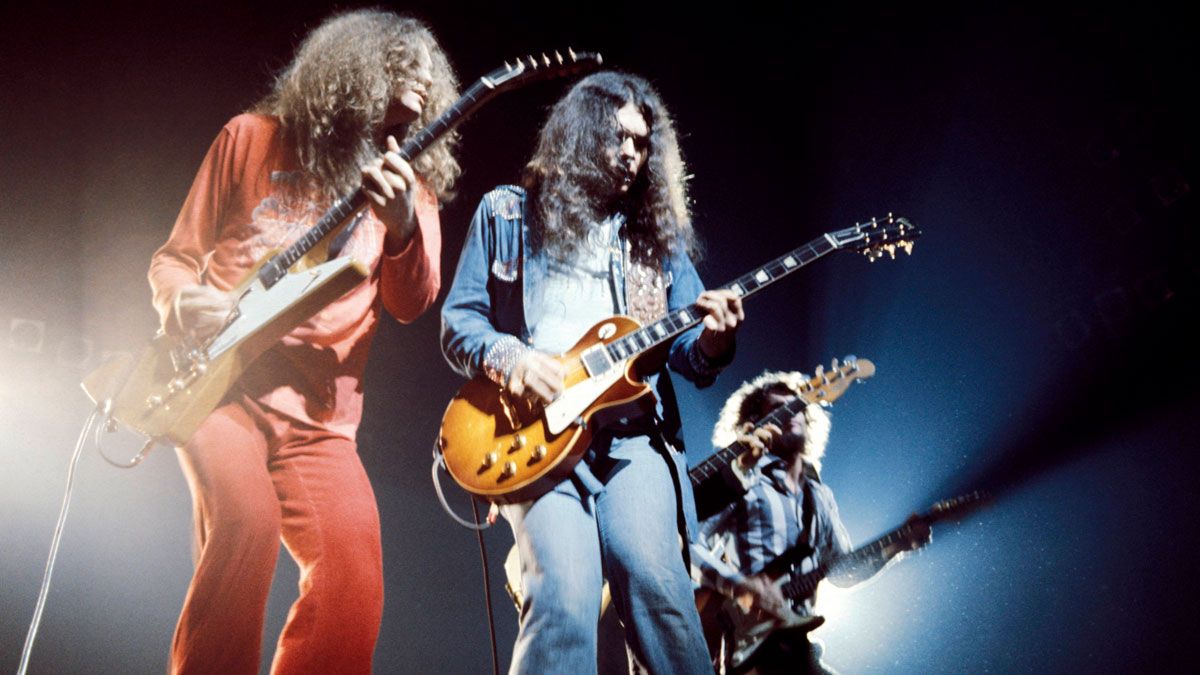 Lynyrd Skynyrd&#039;s Allen Collins, Gary Rossington (playing Gibson Les Paul), Steve Gaines performing live onstage