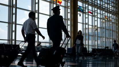 Pilots are seen walking through Ronald Reagan Washington National Airport in Arlington, Virginia.