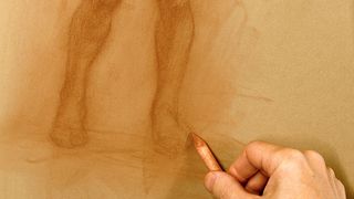 How to draw a figure: Artist blending the edges of the figure using a paper stump