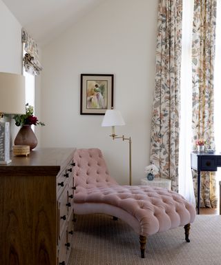 pink chaise longue in bedroom with printed curtains