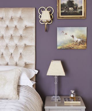 A bedroom color idea with purple walls, and champagne blush velvet headboard