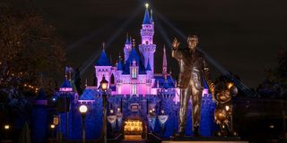 Sleeping Beauty castle and Partners statue at night at Disneyland