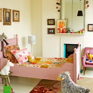 yellow painted wall kids room with pink bed and toys