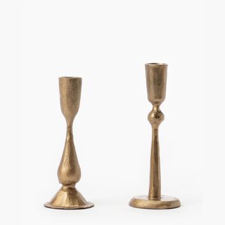 pair of brass candle holders for taper candles in two different lengths