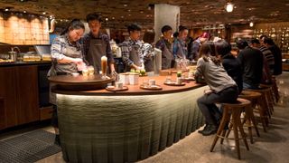 People drinking coffee and socialising in Starbucks cafe