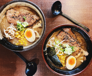 Two bowls of Ramen noodle soup with pork belly