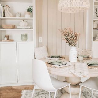 Neutral breakfast nook space with beadboard backing and white decorative accents