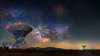 radio telescopes point upwards under the milky way and stars