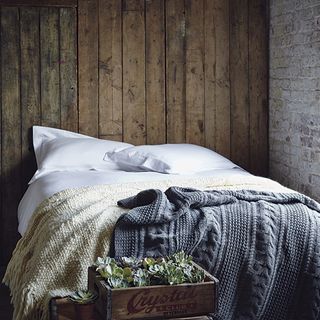 bed with white bedlinen and basket