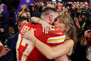 Travis Kelce #87 of the Kansas City Chiefs and Taylor Swift embrace after defeating the San Francisco 49ers in overtime during Super Bowl LVIII.
