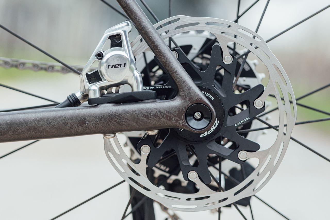 A Sram Red AXS brake caliper and disc rotor