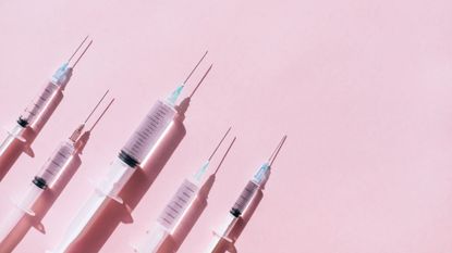 Black market Ozempic: Needles against a pink background