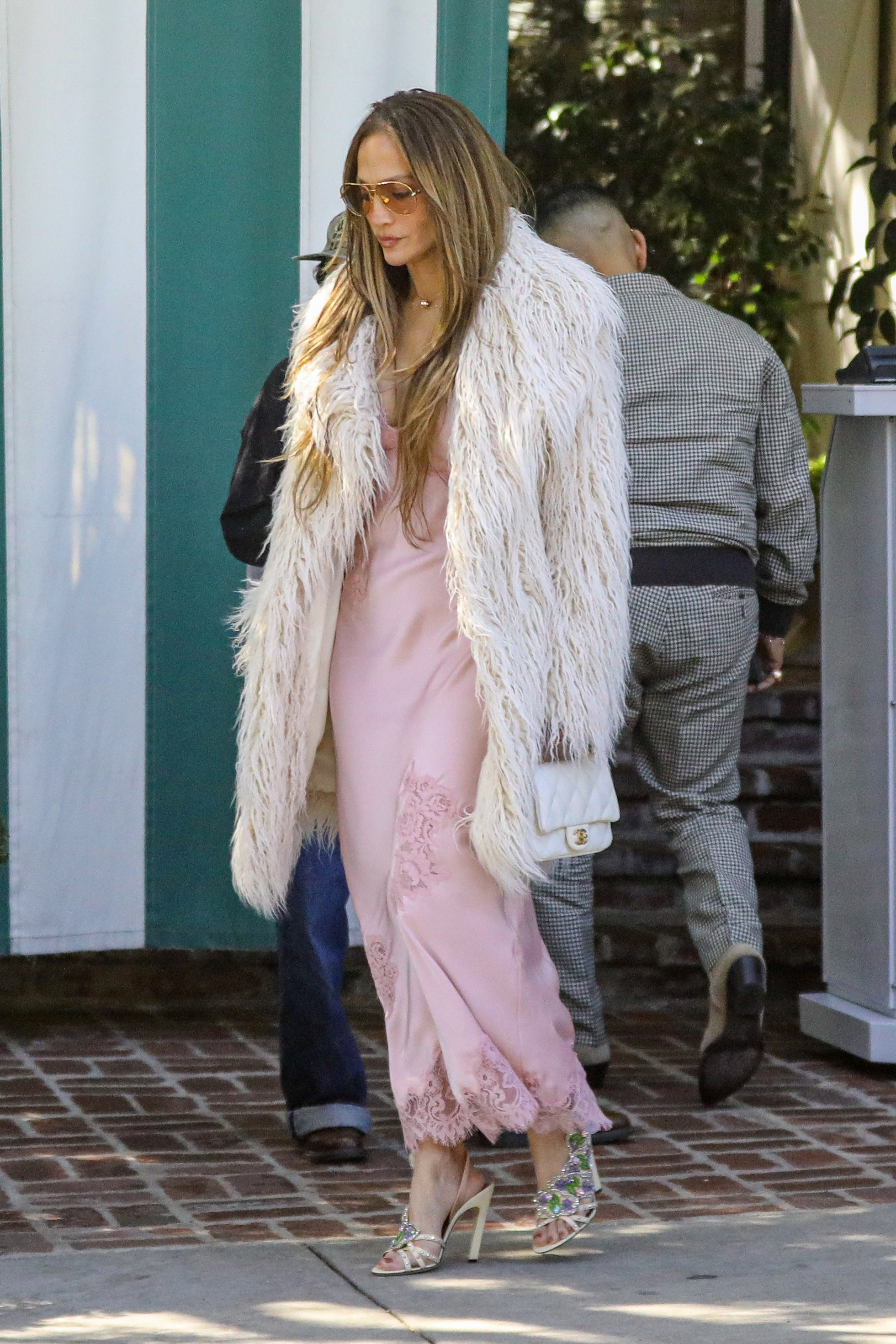 Jennifer Lopez wore the peony pink color trend on her lace-trimmed slip dress
