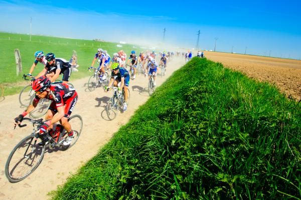 Blue skies, green fields, cobbles, dust, and a race.