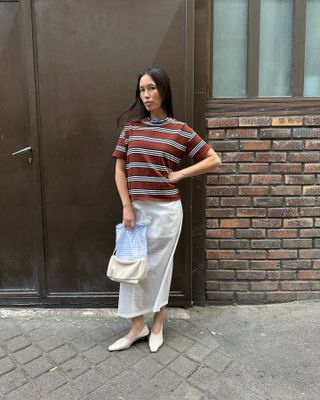 striped shirt + skirt — what women wear while shopping in europe