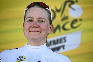 Uno-X Mobility team's Finnish rider Anniina Ahtosalo celebrates on the podium with the best young rider's white jersey after the first stage (out of 8) of the third edition of the Women's Tour de France cycling race a 123 km individual time trial between Rotterdam and The Hague, on August 12, 2024. (Photo by JULIEN DE ROSA / AFP)