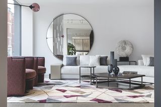 Living room interior with pink and white furniture and geometric rug by Giorgetti in its London showroom