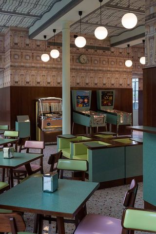 The colour colour palette of the Formica furniture and veneered wooden panelling alludes to the Milanese cafes