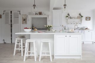 vintage kitchen with white cabinets and white island