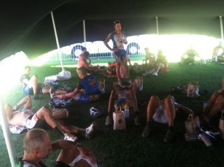 Racers recuperate from a hot stage in the shade of a tent