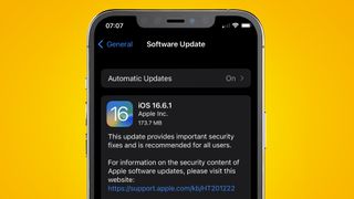 An iPhone on a yellow background showing an iOS update message