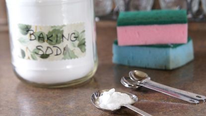 Baking soda in a pot and in a spoon plus pots