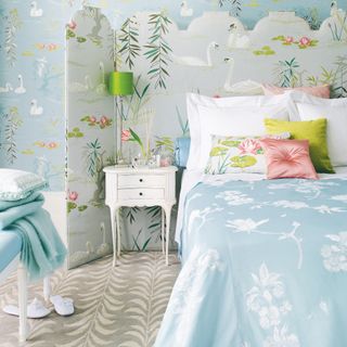 aqua and pale blue floral bedroom with two tone carpet, screen behind bed, lime green accents