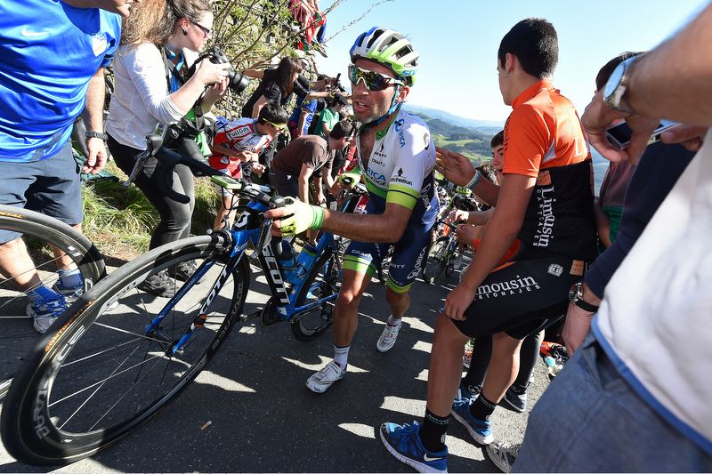 Michael Albasini (Orica-GreenEdge) pushes his bike up the climb