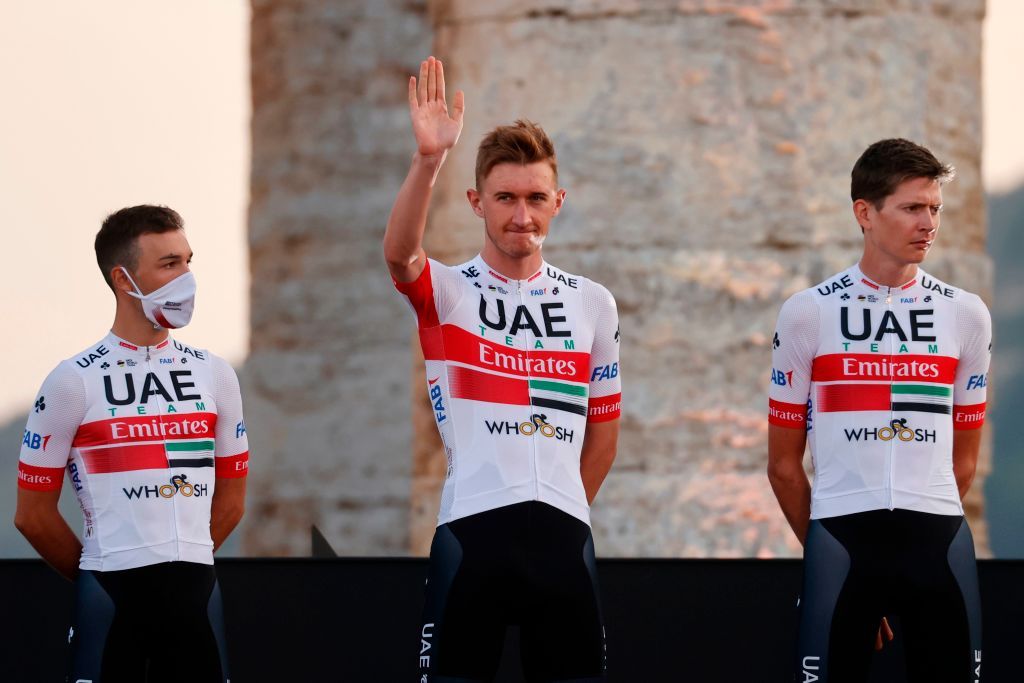 Team UAE Emirates rider Denmarks Mikkel Bjerg C waves on stage at the Doric Temple of Segesta near Palermo Sicily on October 1 2020 during an opening ceremony of presentation of participating teams and riders two days ahead of the departure of the Giro dItalia 2020 cycling race Photo by Luca Bettini AFP Photo by LUCA BETTINIAFP via Getty Images