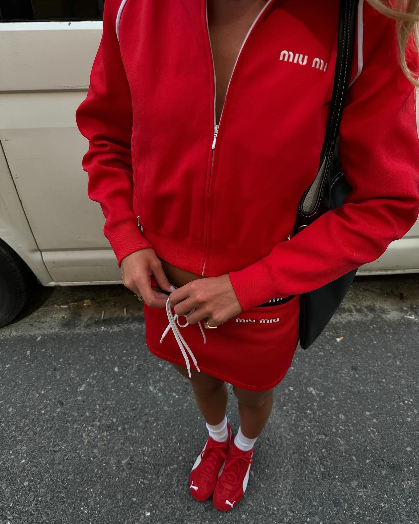 Fashion person Emilisindlev wears a trending trainer brand 2026. She wears red puma Speedcats. She wears them with a all red Mu Miu outfit. This image was recently taken from her Instagram.