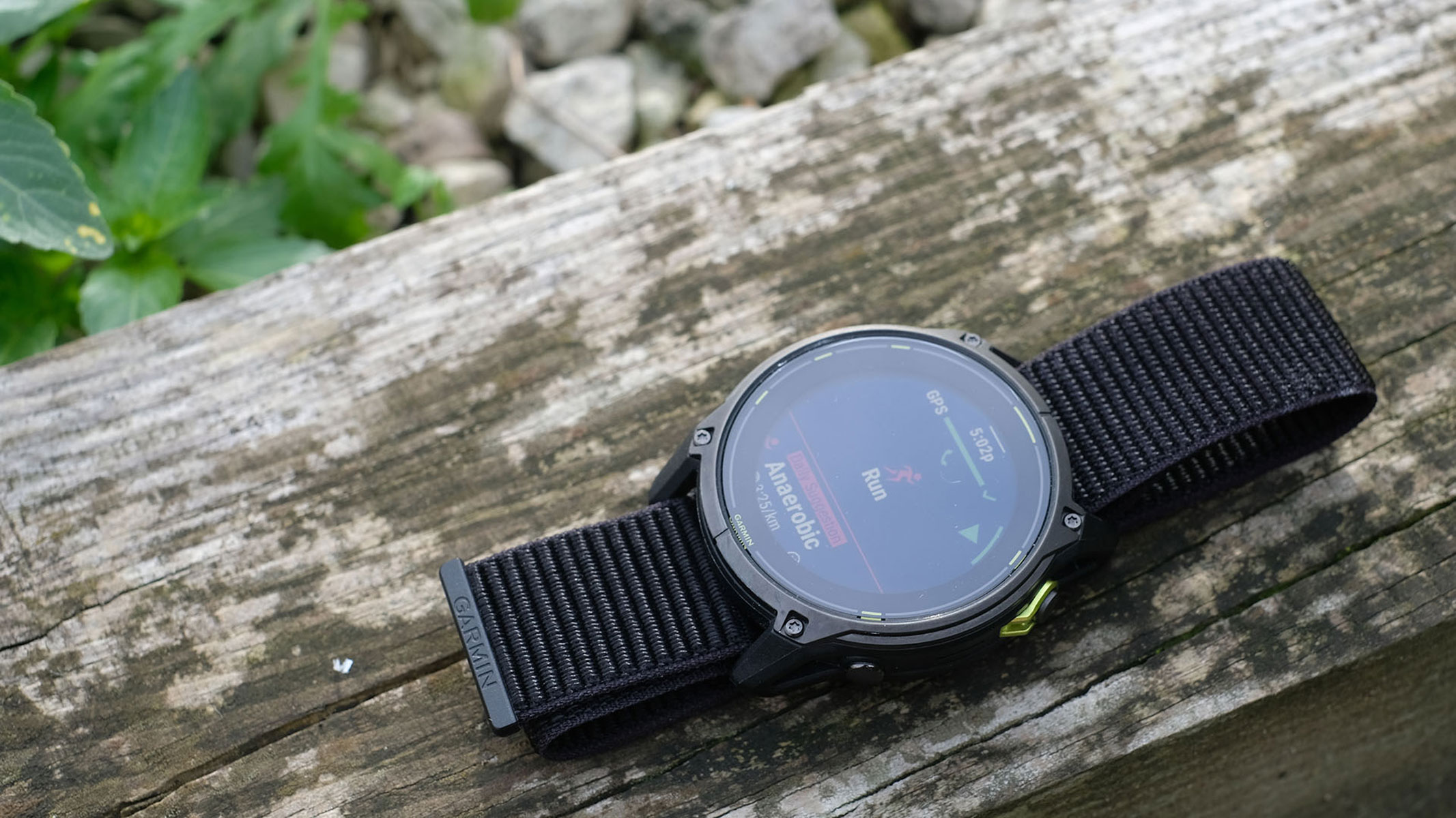 A picture of the Garmin Enduro 3 smartwatch sitting on top of a wooden plank