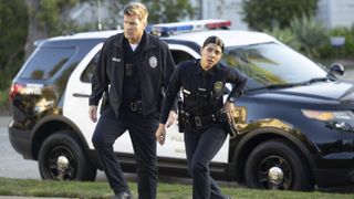 Nathan Fillion and Lisseth Chavez as John and Celina in uniform in The Rookie season 6