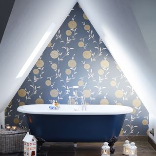 attic bathroom with navy wallpaper and navy bathtub