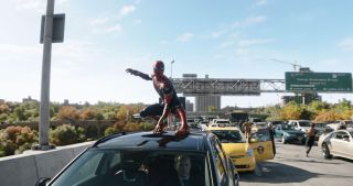 Spider-Man standing on top of a car in the new No Way Home film