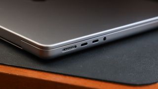 Close up of the USB and MagSafe ports of an Apple MacBook Pro sitting on a desk