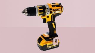 Dewalt 18V XR Brushless Compact Lithium-Ion Combi Drill on pink background