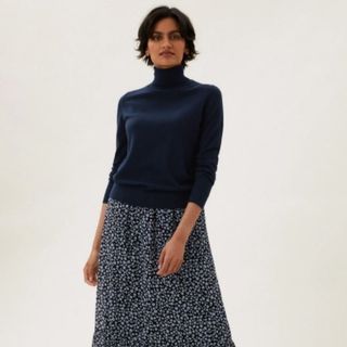 Navy merino wool roll neck shown on model, paired with floral boho skirt