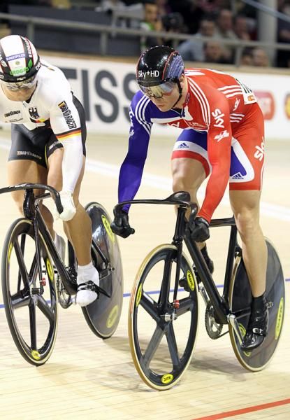 Chris Hoy (Great Britain) is caught napping as Robert Forstemann (Germany) attacks down the banking right from the start of their sprint heat.