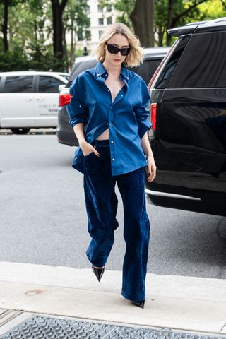 Saoirse Ronan in blue velvet pants and button-down.